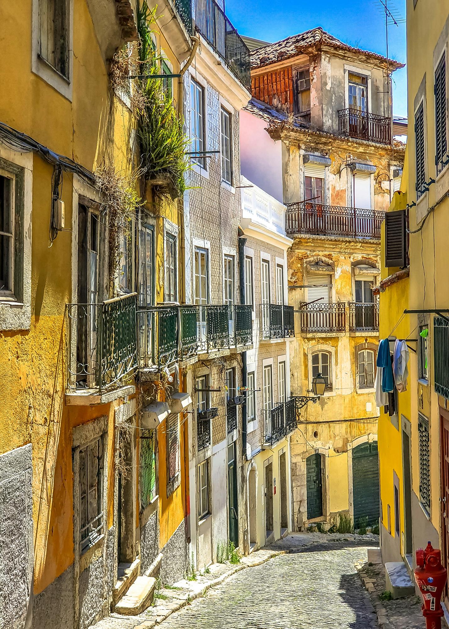 Cobblestone narrow street in between tall buildings